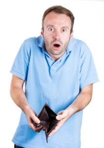 Shocked, broke man holding empty wallet,
